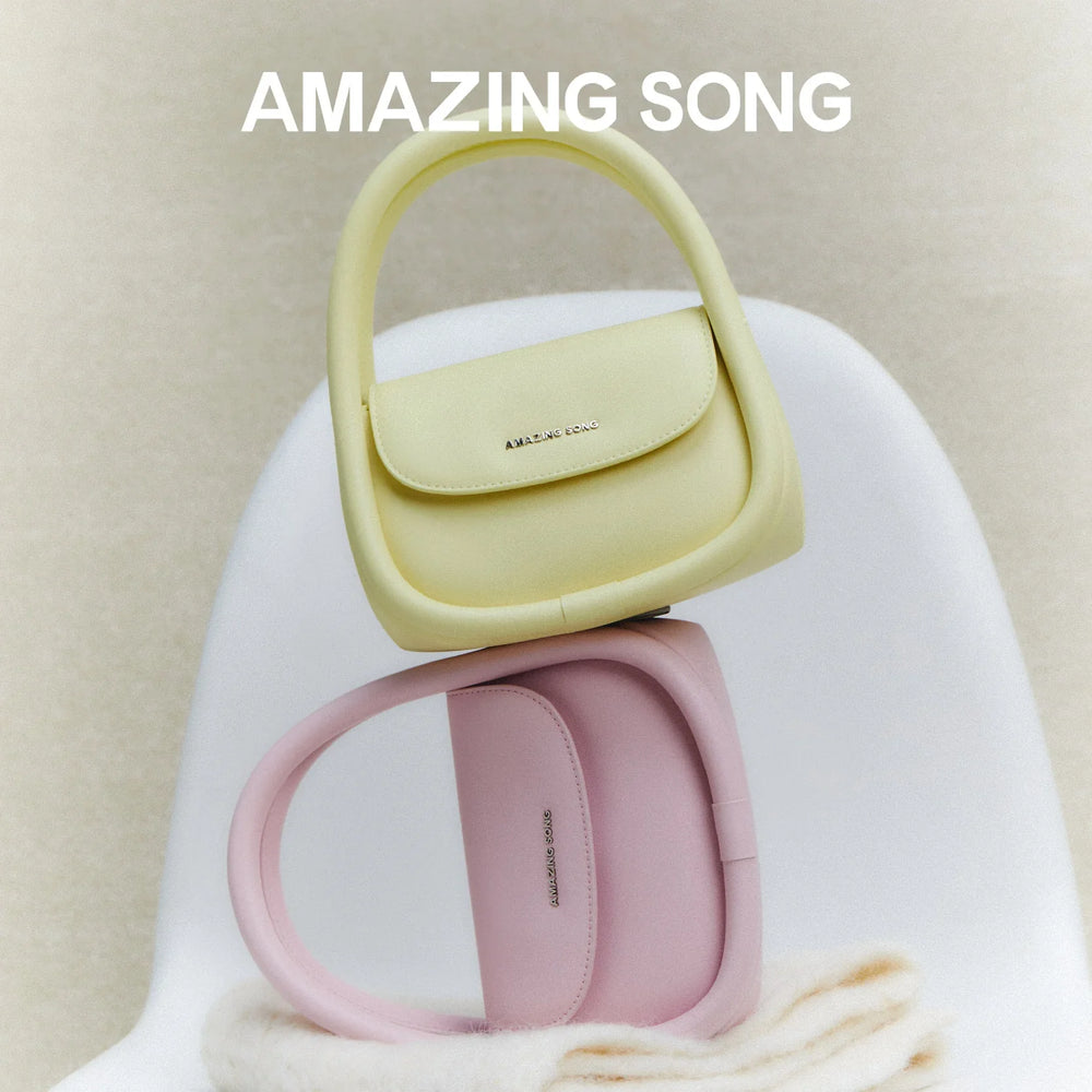 Amazing Song pastel yellow and pink handbags on a white chair, official website promo