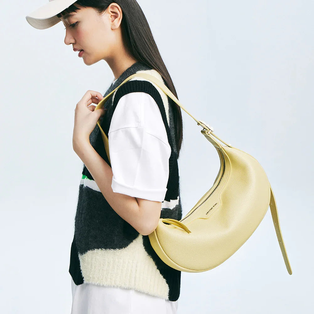 Woman in casual outfit with yellow shoulder bag from Amazing Song, side profile