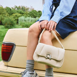 Woman holding cream handbag on vintage car, Amazing Song brand fashion accessory outdoors