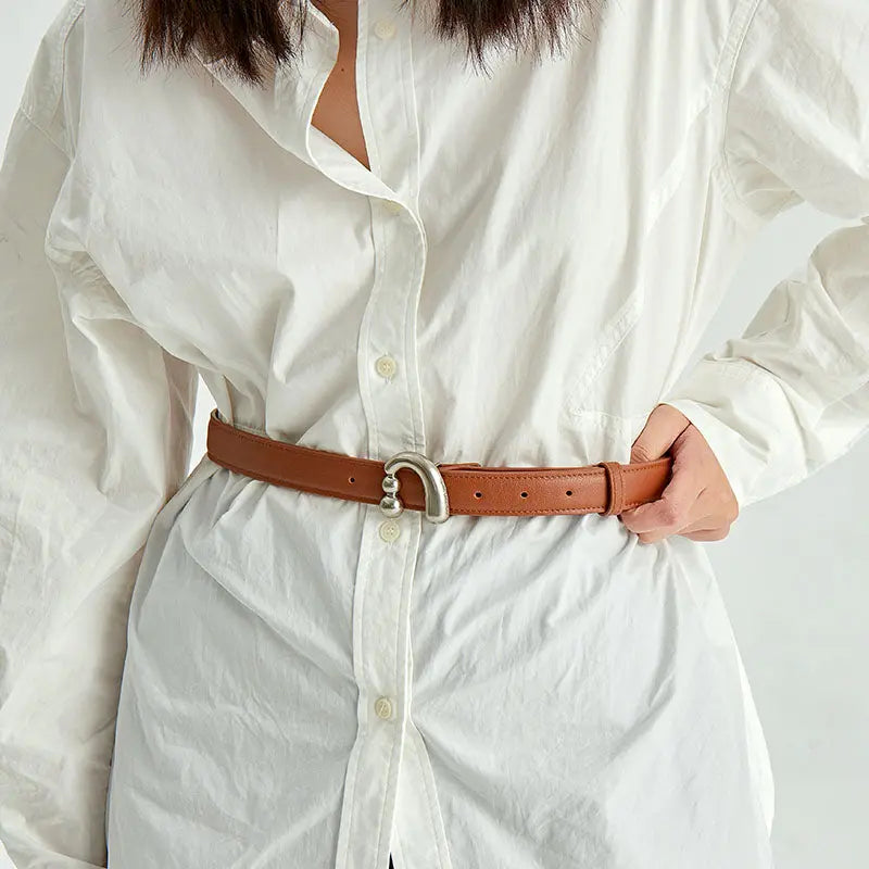 White button-up shirt styled with a brown leather belt, Amazing Song fashion accessory
