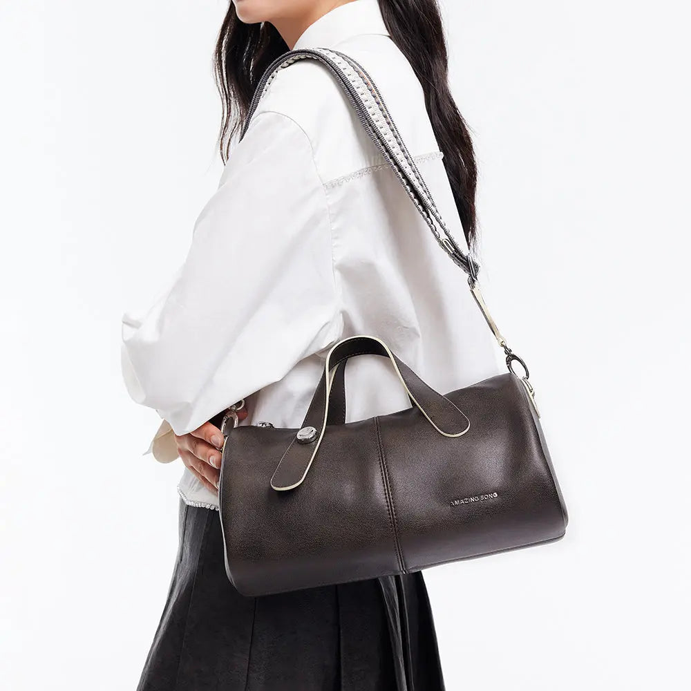 Woman carrying dark brown Amazing Song handbag with white shirt and black skirt
