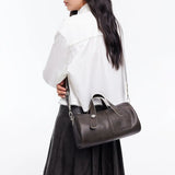 Woman in white blouse carrying black leather handbag, Amazing Song official website style
