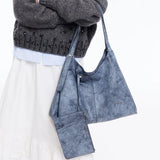 Woman carrying blue marbled tote bag with matching pouch, Amazing Song official website