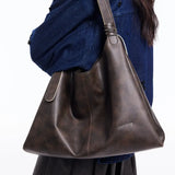 Amazing Song brown leather shoulder bag on model in blue denim jacket
