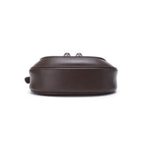 Bottom view of a brown leather handbag on white background, Amazing Song official website