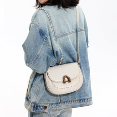 Woman in denim jacket with white crossbody bag, Amazing Song fashion accessory