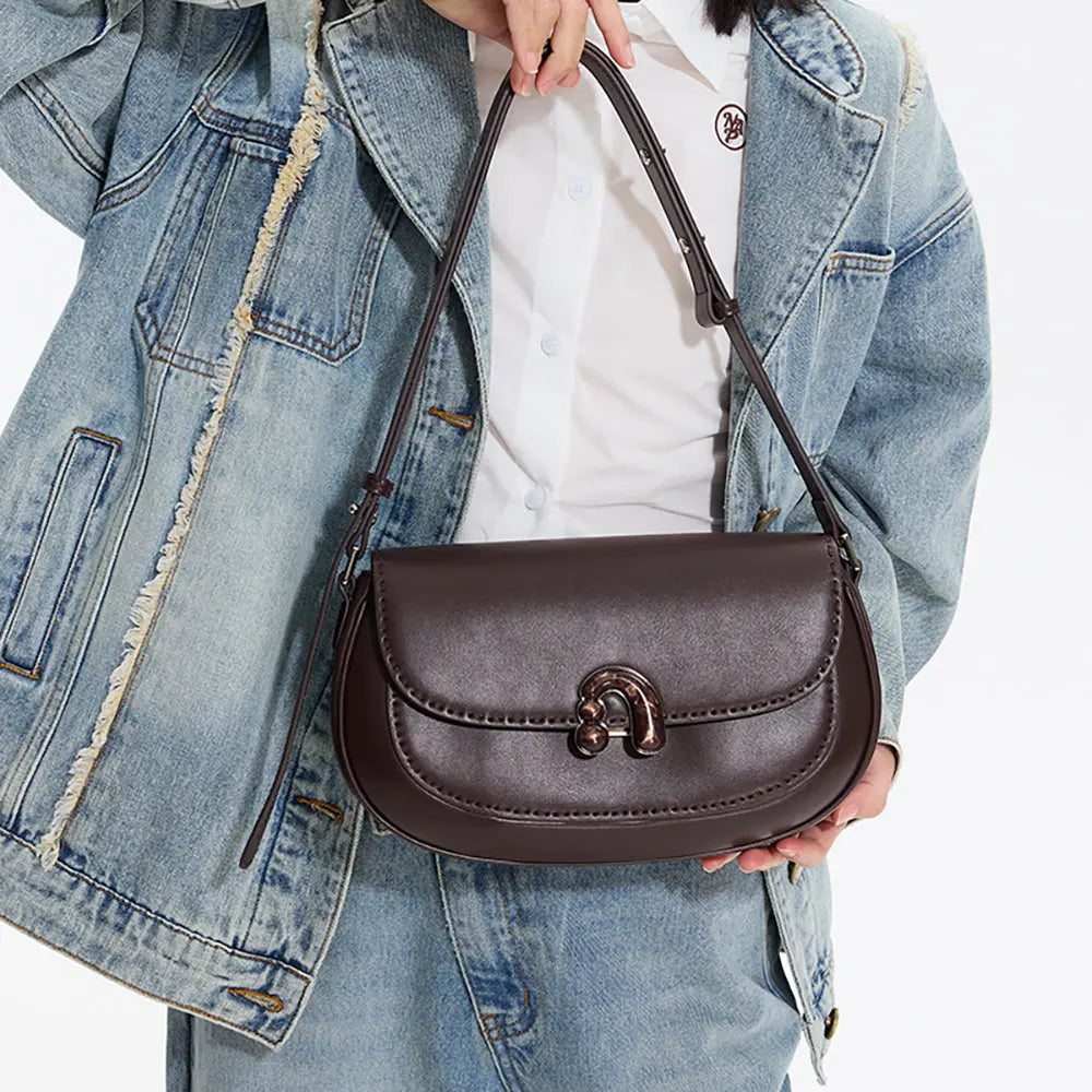 Woman in denim jacket holding stylish dark brown leather shoulder bag, Amazing Song
