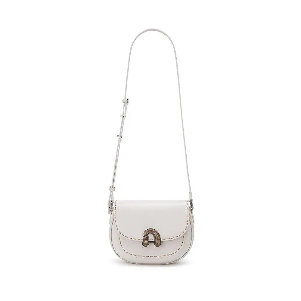 White leather shoulder bag with metal clasp and contrast stitching on white background