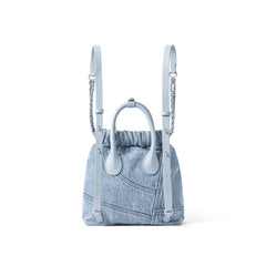 Light blue denim backpack with leather straps, chain accents, on white background