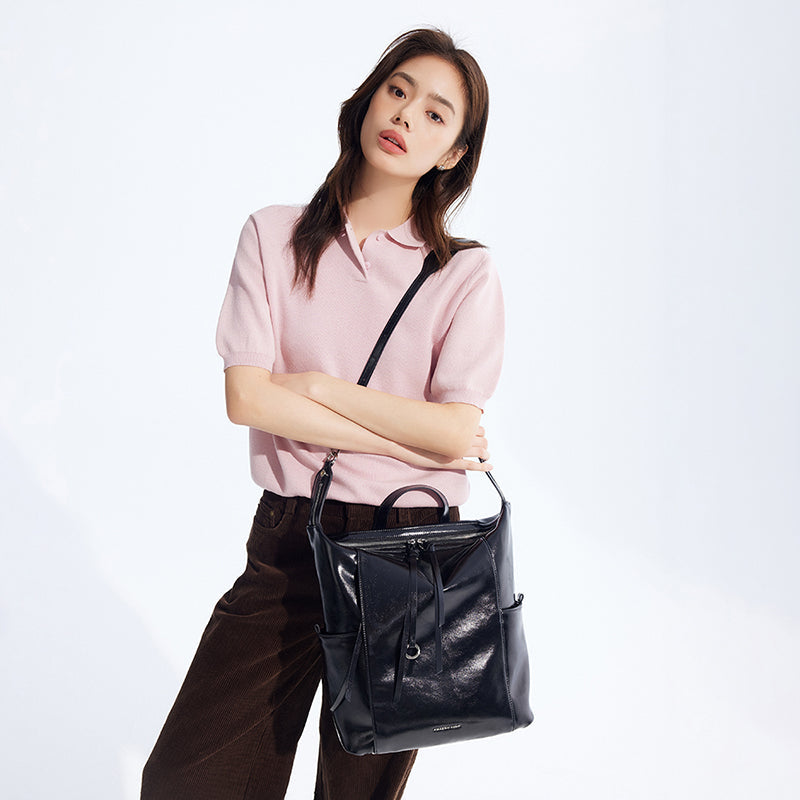 Woman in pink top with black leather handbag, Amazing Song official website product image