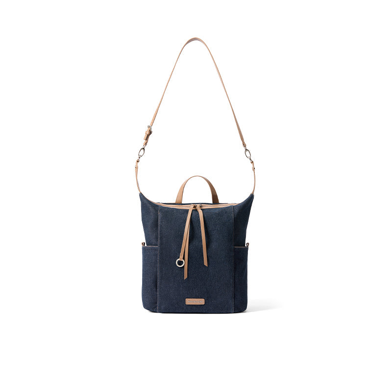 Navy blue canvas shoulder bag with tan leather straps and front pocket, Amazing Song