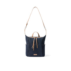 Navy blue canvas shoulder bag with tan leather straps and front pocket, Amazing Song
