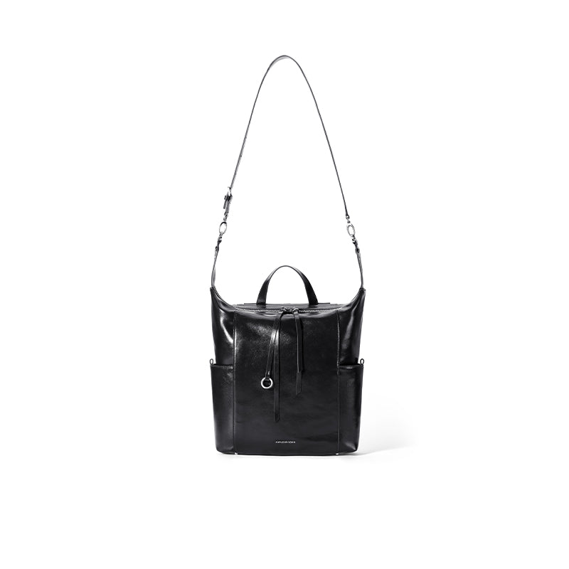 Sleek black leather backpack with long strap, front drawstring, and side pockets on white background