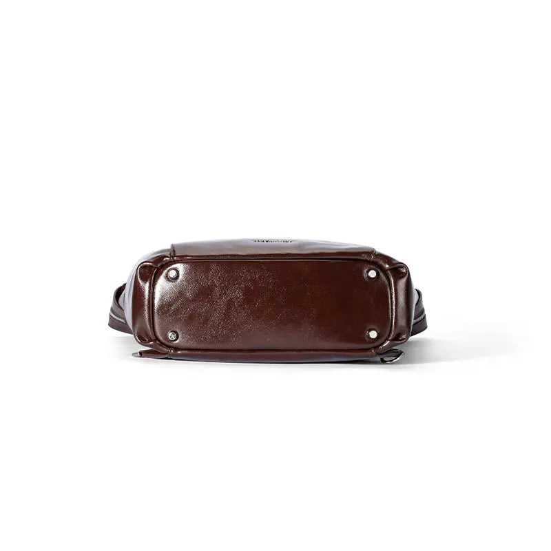 Bottom view of a dark brown leather bag with silver feet, Amazing Song official website