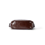 Bottom view of a dark brown leather bag with silver feet, Amazing Song official website