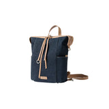 Dark blue canvas backpack with tan leather straps, displayed on white background