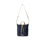 Dark blue denim shoulder bag with tan leather straps on white background, Amazing Song