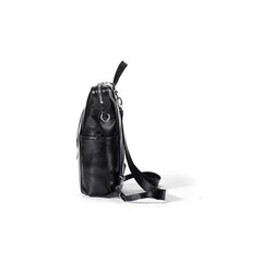 Side view of stylish black leather sling backpack with metal hardware on white background