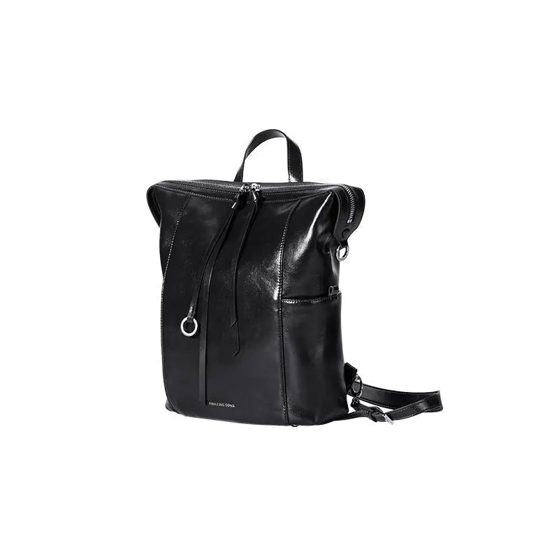 Amazing Song sleek black leather backpack with zipper and silver detail on white background