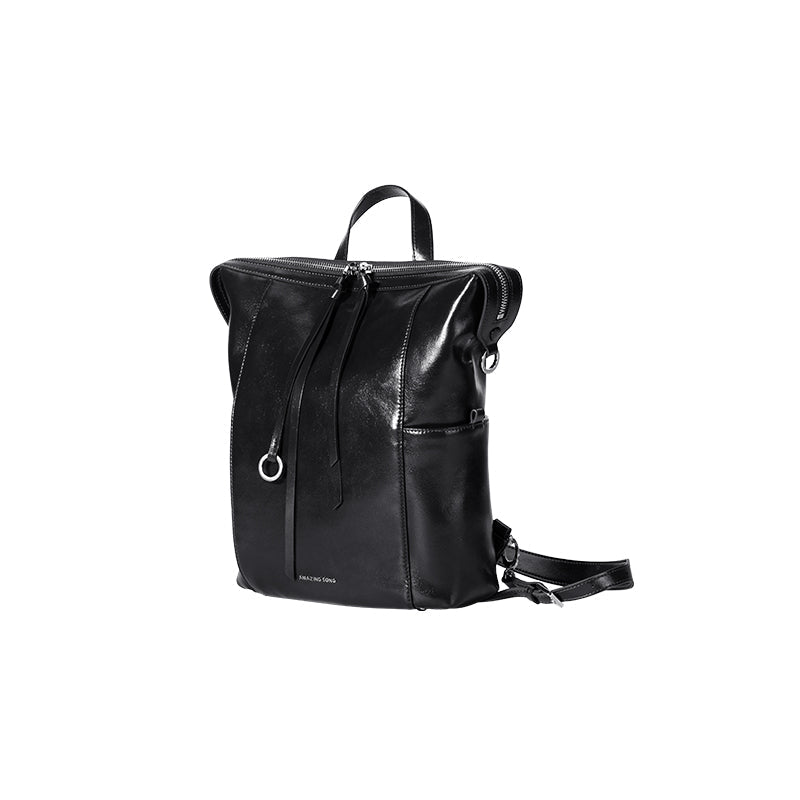 Amazing Song sleek black leather backpack with zipper and silver detail on white background