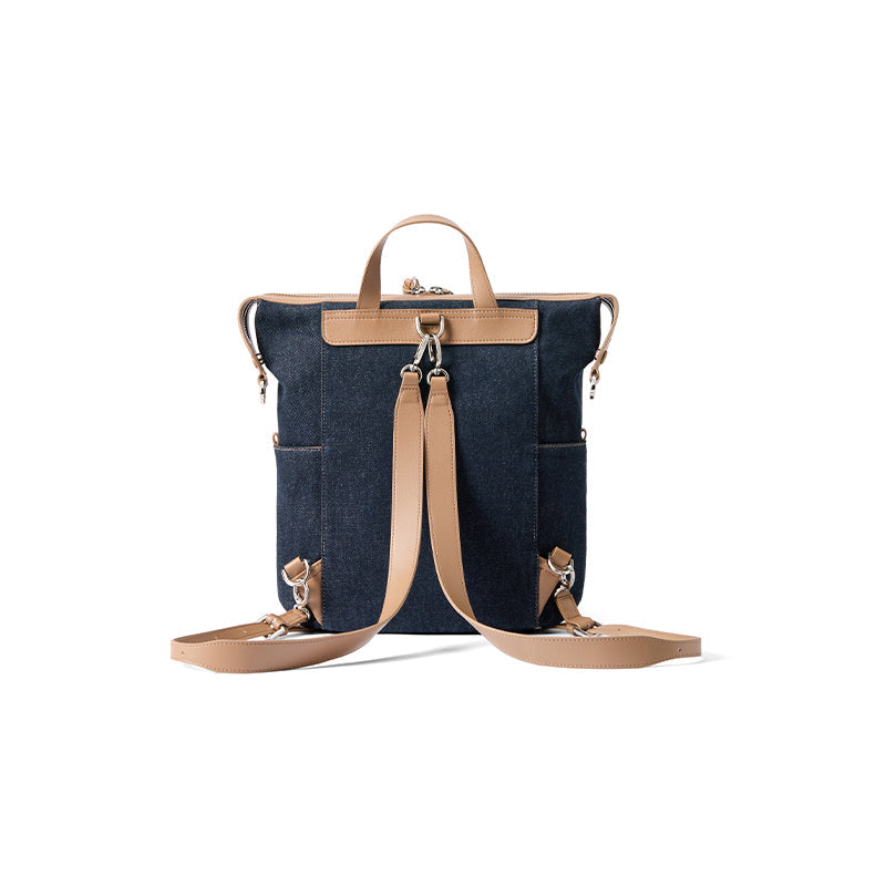 Denim backpack with tan leather straps on white background, Amazing Song official website