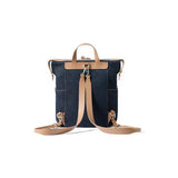 Denim backpack with tan leather straps on white background, Amazing Song official website