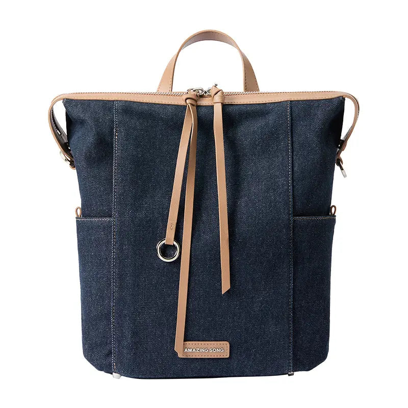 Amazing Song denim backpack with tan leather straps and front logo patch