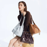 Woman modeling three stylish bucket bags in different colors for Amazing Song official website
