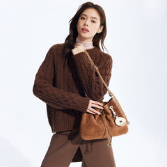 Woman in brown cable-knit sweater holding tan suede shoulder bag, Amazing Song official website