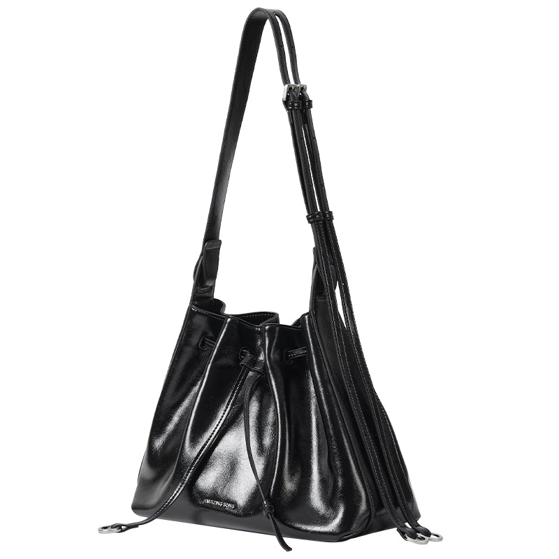 Black leather bucket bag with adjustable strap, Amazing Song branding, product photo