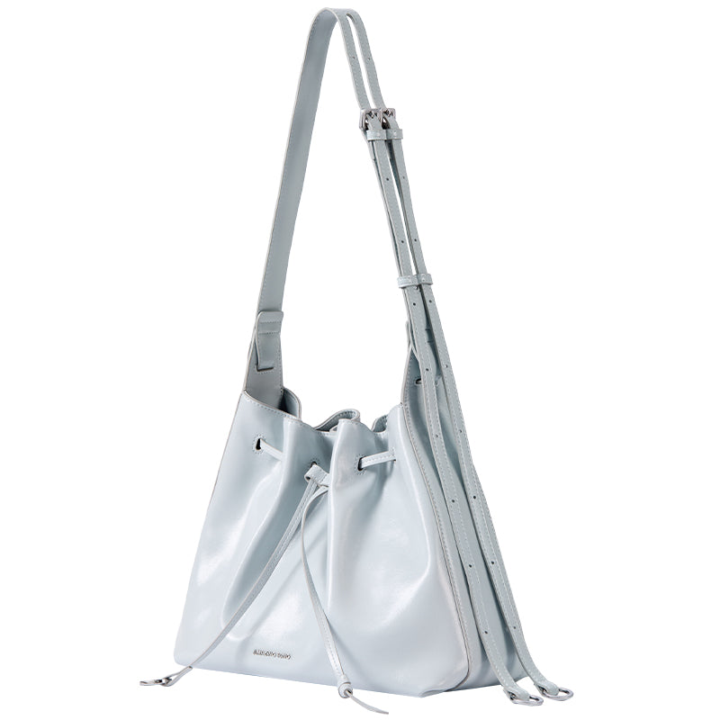 Light blue leather bucket bag with adjustable strap, Amazing Song accessory on white background
