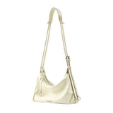 Cream leather shoulder bag with adjustable strap and silver hardware on white background
