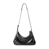 Sleek black leather shoulder bag with adjustable strap on white background, Amazing Song