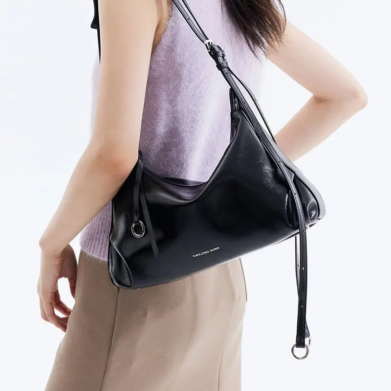 Woman wearing a black Amazing Song shoulder bag, stylish fashion accessory