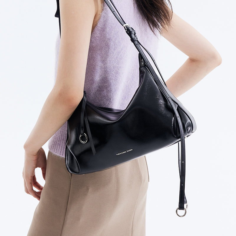 Woman wearing a black Amazing Song shoulder bag, stylish fashion accessory