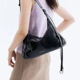 Woman wearing a black Amazing Song shoulder bag, stylish fashion accessory