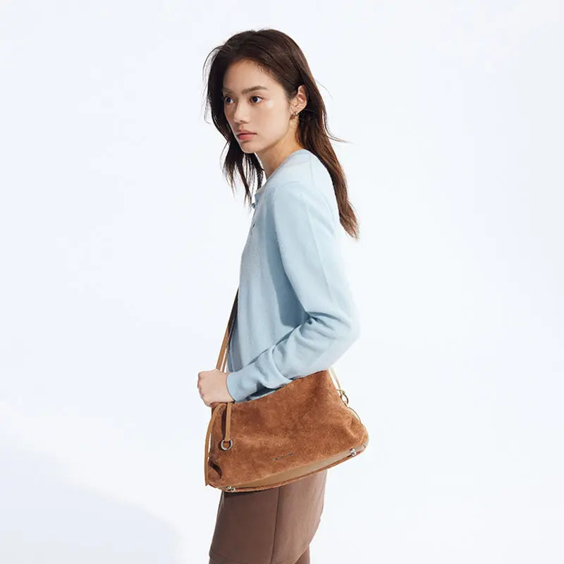 Woman in light blue sweater with brown suede shoulder bag, Amazing Song fashion