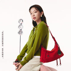 Woman in green sweater with red shoulder bag, Amazing Song official website fashion