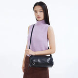 Woman in sleeveless lavender top modeling black leather shoulder bag, Amazing Song style
