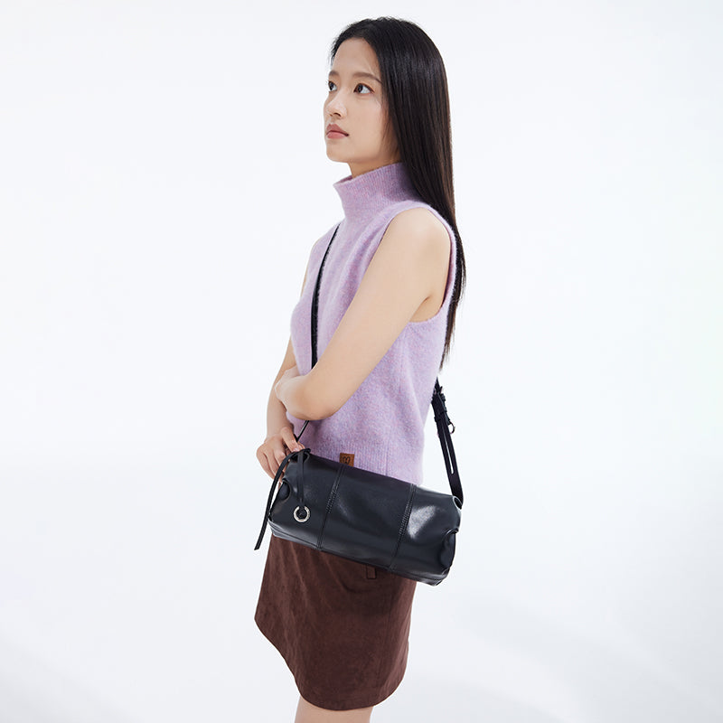 Woman in lilac sleeveless turtleneck and brown skirt with black shoulder bag, Amazing Song