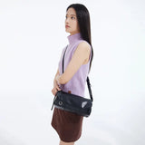 Woman in lilac sleeveless turtleneck and brown skirt with black shoulder bag, Amazing Song