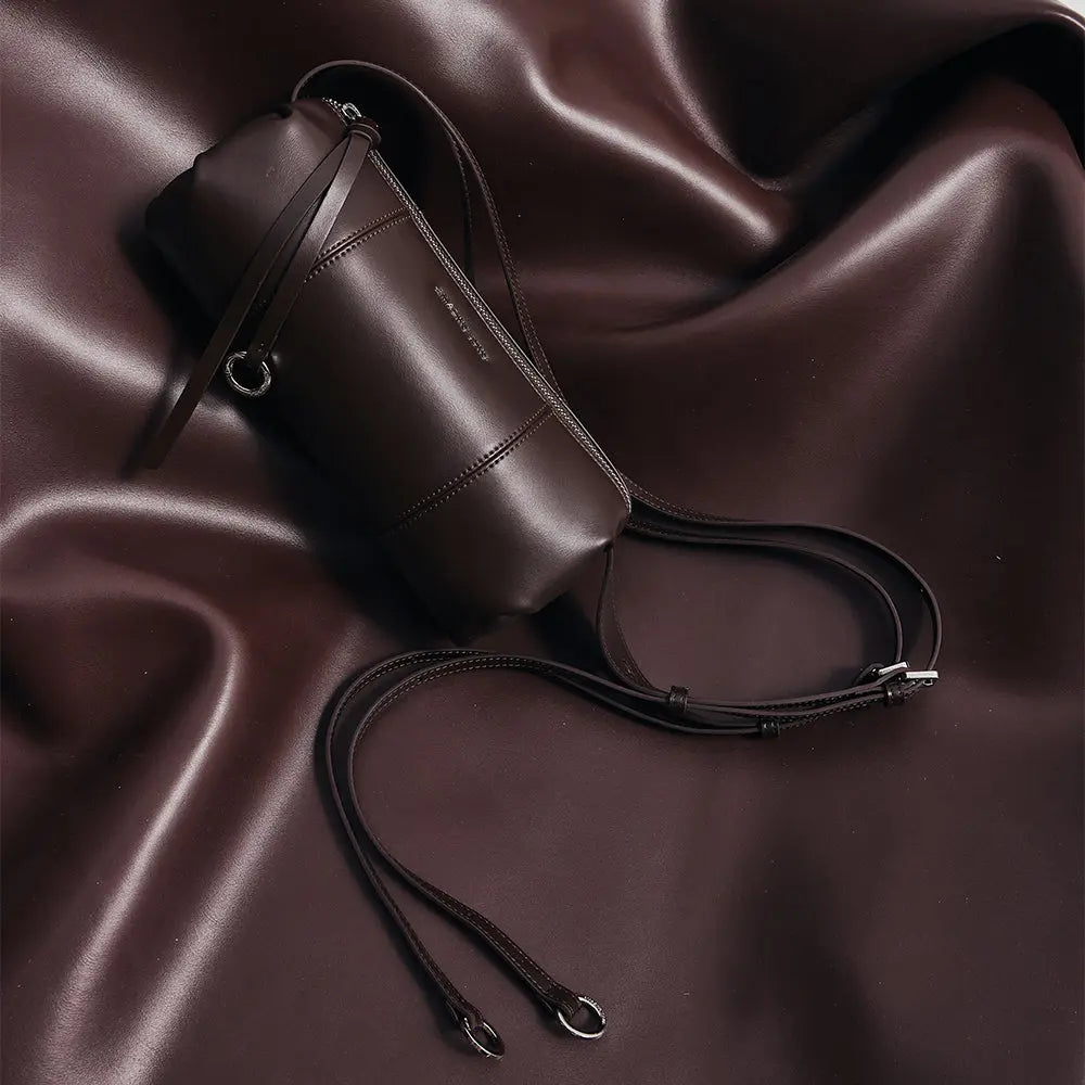 Dark brown leather cylinder bag with strap on matching brown fabric, Amazing Song accessories
