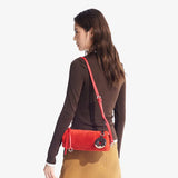 Woman wearing brown top and tan skirt with red suede shoulder bag, Amazing Song fashion