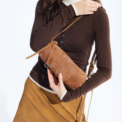 Woman holding suede brown shoulder bag, wearing brown top and camel skirt from Amazing Song