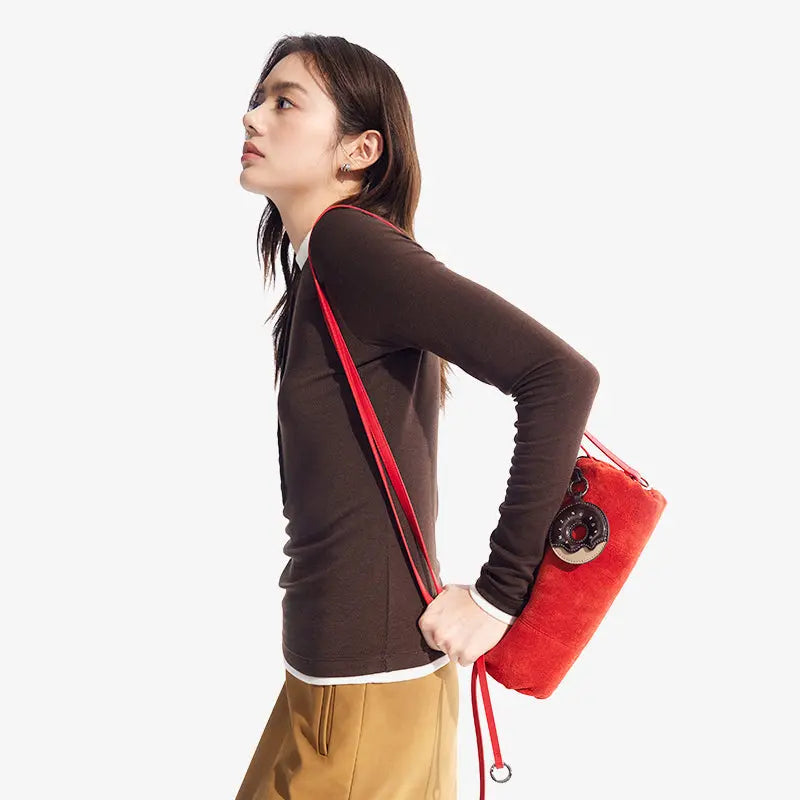 Woman wearing brown top with red shoulder bag, Amazing Song official website product
