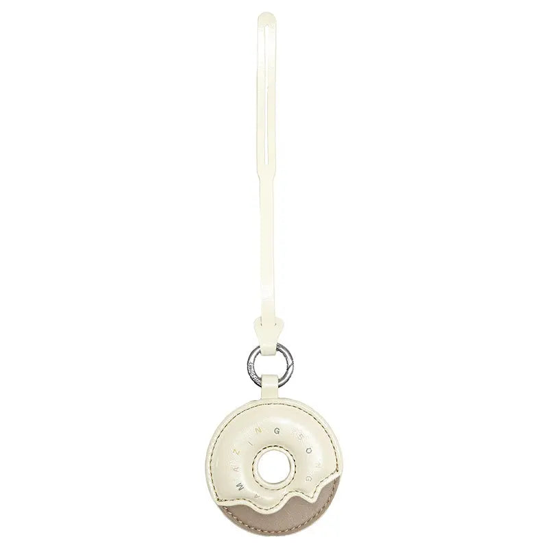 Cream and beige donut-shaped Amazing Song leather keychain with strap on white background
