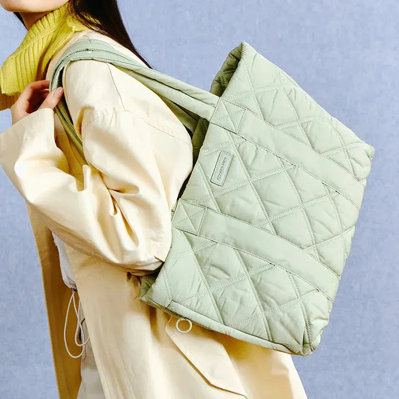 Woman carrying light green quilted tote bag from Amazing Song, stylish soft accessory