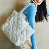Woman carrying large quilted white tote bag, Amazing Song website style accessory