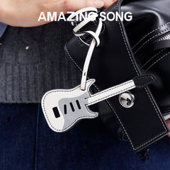 Amazing Song guitar-shaped keychain on black leather bag
