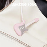 Pink guitar-shaped bag charm on cream backpack, Amazing Song branding visible